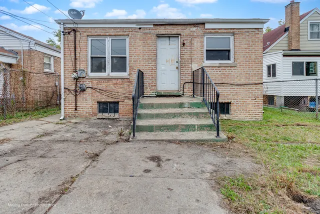 a view of a house with a yard and stairs