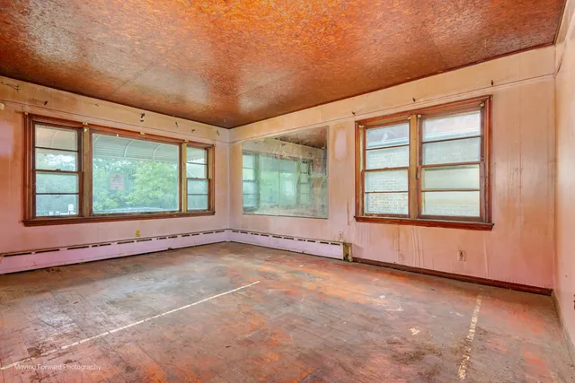 an empty room with large windows