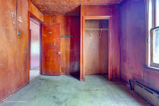 a view of a room with red walls and stairs