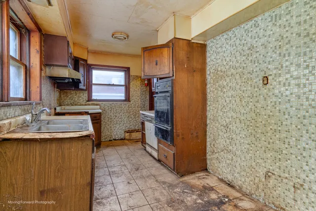 a kitchen with a sink and refrigerator