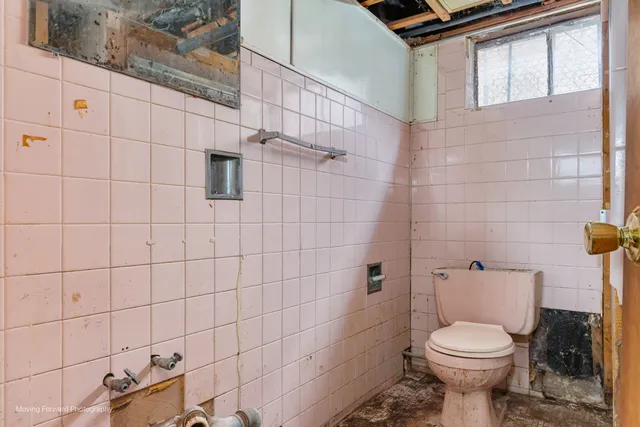 a white toilet sitting next to a bathroom sink