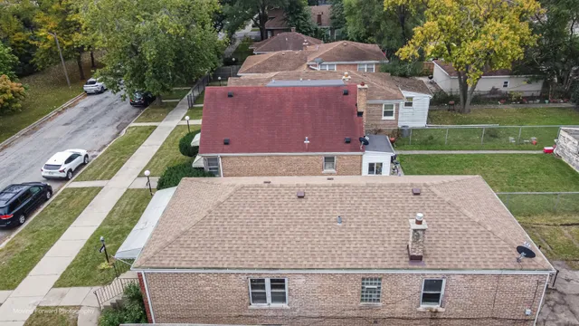 an aerial view of a house with a yard