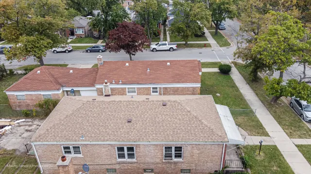 an aerial view of a house with a yard
