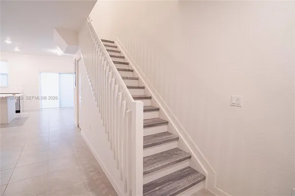 a view of a hallway with stairs