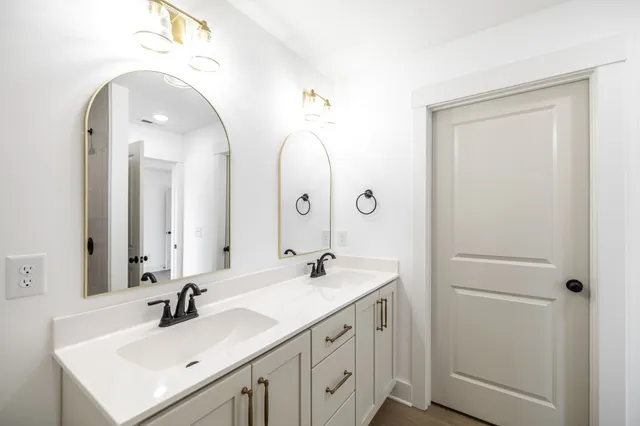 a bathroom with a double vanity sink and a mirror