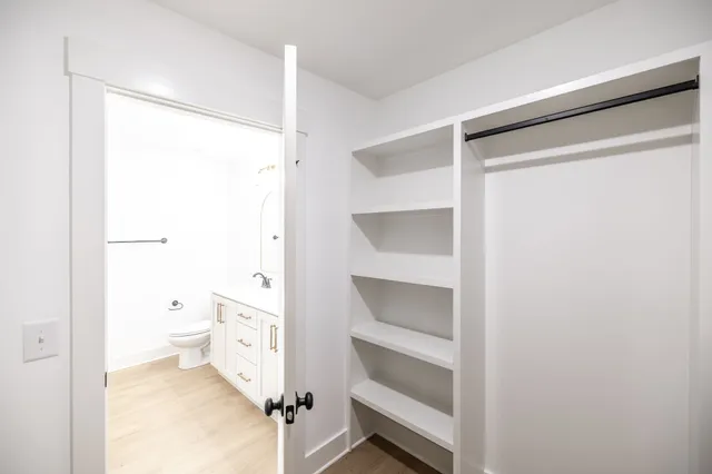 a bathroom with a double vanity sink and a toilet