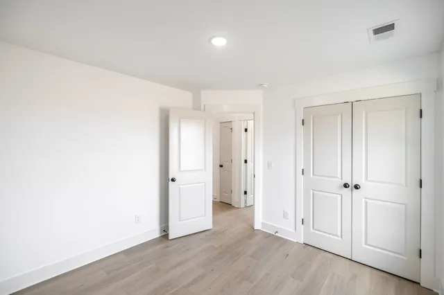 an empty room with wooden floor