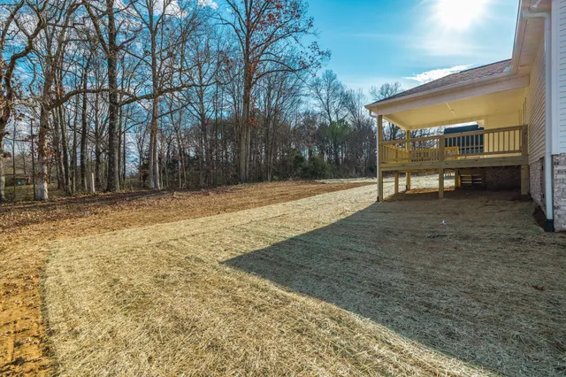 a view of a yard with wooden fence