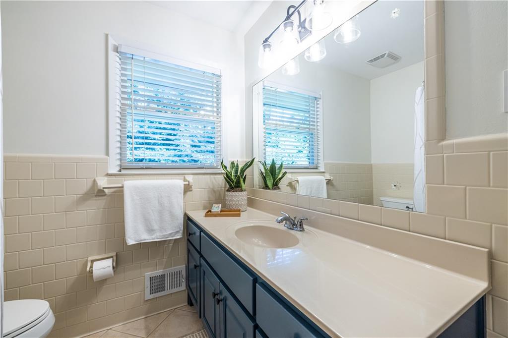 1890 Silvastone Drive Decatur, GA 30033 - Photo 26 of 48 a bathroom with a sink a toilet and large mirror