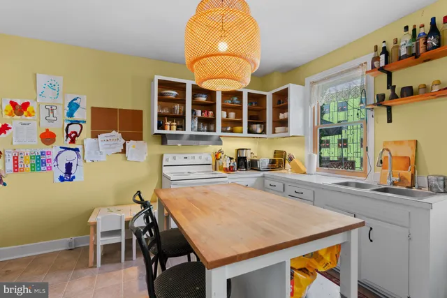 a view of a kitchen with a table and chairs