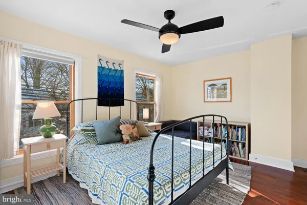 a bedroom with a bed a couch and a window