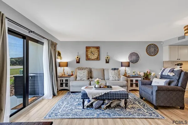 a living room with furniture wooden floor and a rug