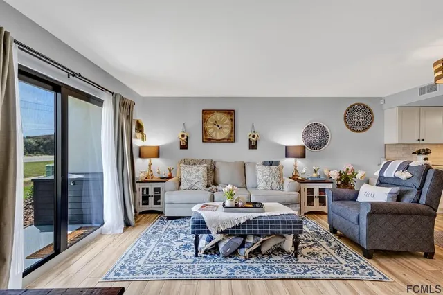 a living room with furniture wooden floor and a rug