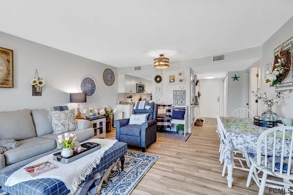 a living room with furniture kitchen view and a table