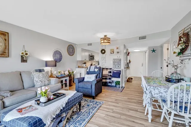 a living room with furniture kitchen view and a table