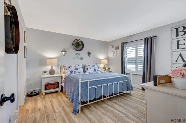 a bedroom with a bed and a large window