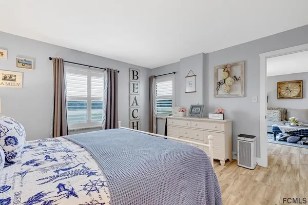 a bedroom with a large bed and a window
