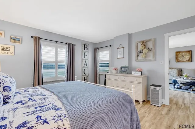 a bedroom with a large bed and a window