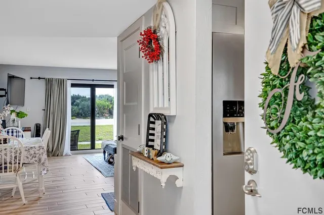 a view of a livingroom with wooden floor and a potted plant