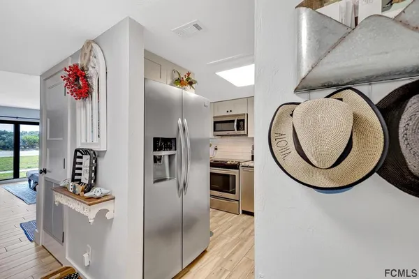 a kitchen with stainless steel appliances granite countertop a refrigerator and a stove