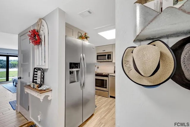 a kitchen with stainless steel appliances granite countertop a refrigerator and a stove