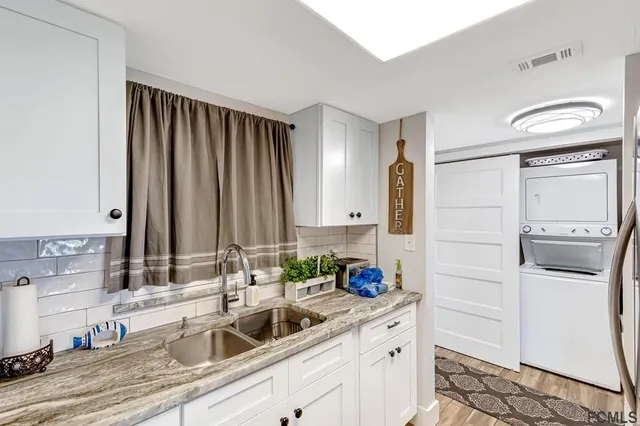 a kitchen with stainless steel appliances a sink and cabinets