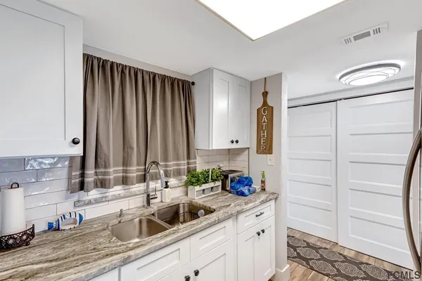 a kitchen with appliances cabinets and a sink