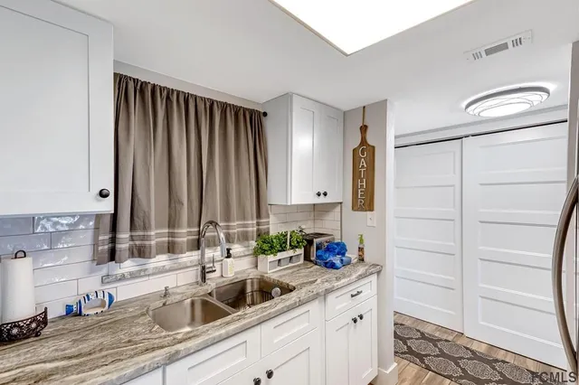 a kitchen with appliances cabinets and a sink