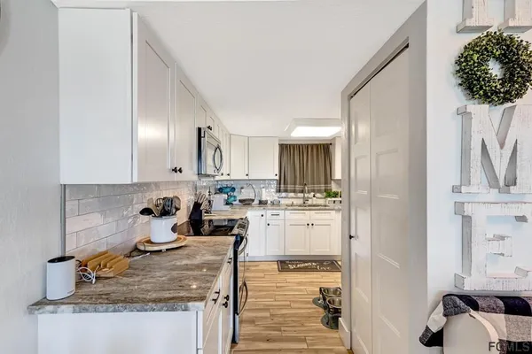 a kitchen with a sink stove and refrigerator