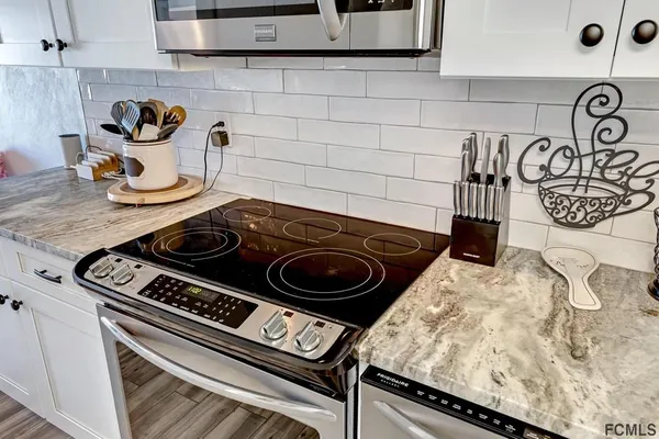 a stove top oven sitting inside of a kitchen