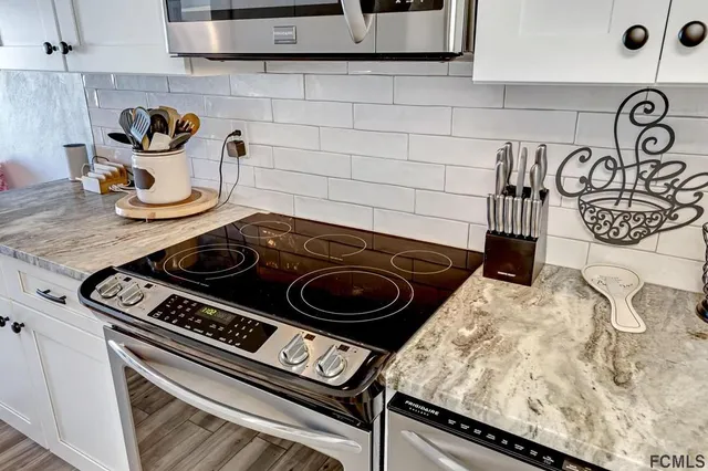 a stove top oven sitting inside of a kitchen