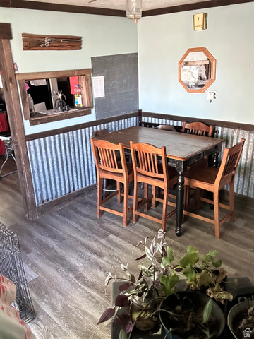 102 South Main Street Paris, ID 83261 - Photo 9 of 33 Dining space featuring dark wood-type flooring and a wainscoted wall