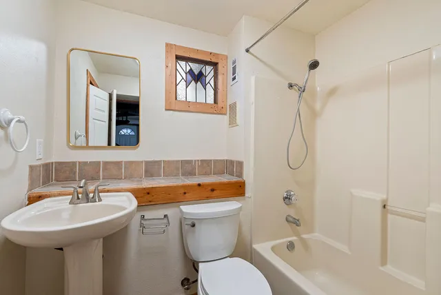 a bathroom with a sink toilet and shower