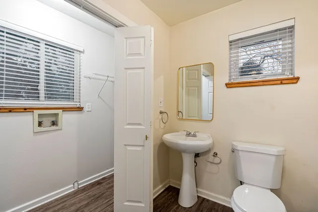 a bathroom with a toilet sink and mirror