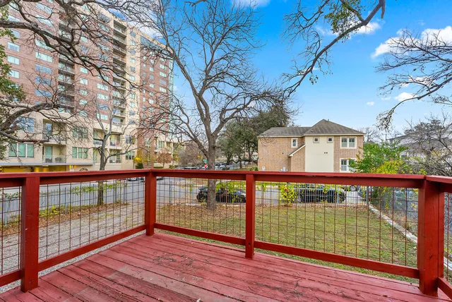 a view of a balcony with wooden floor