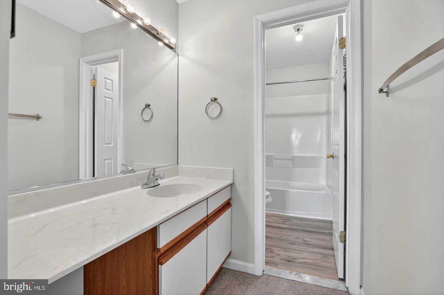 23 Janwall Court Annapolis, MD 21403 - Photo 12 of 28 a bathroom with a granite countertop sink and a mirror