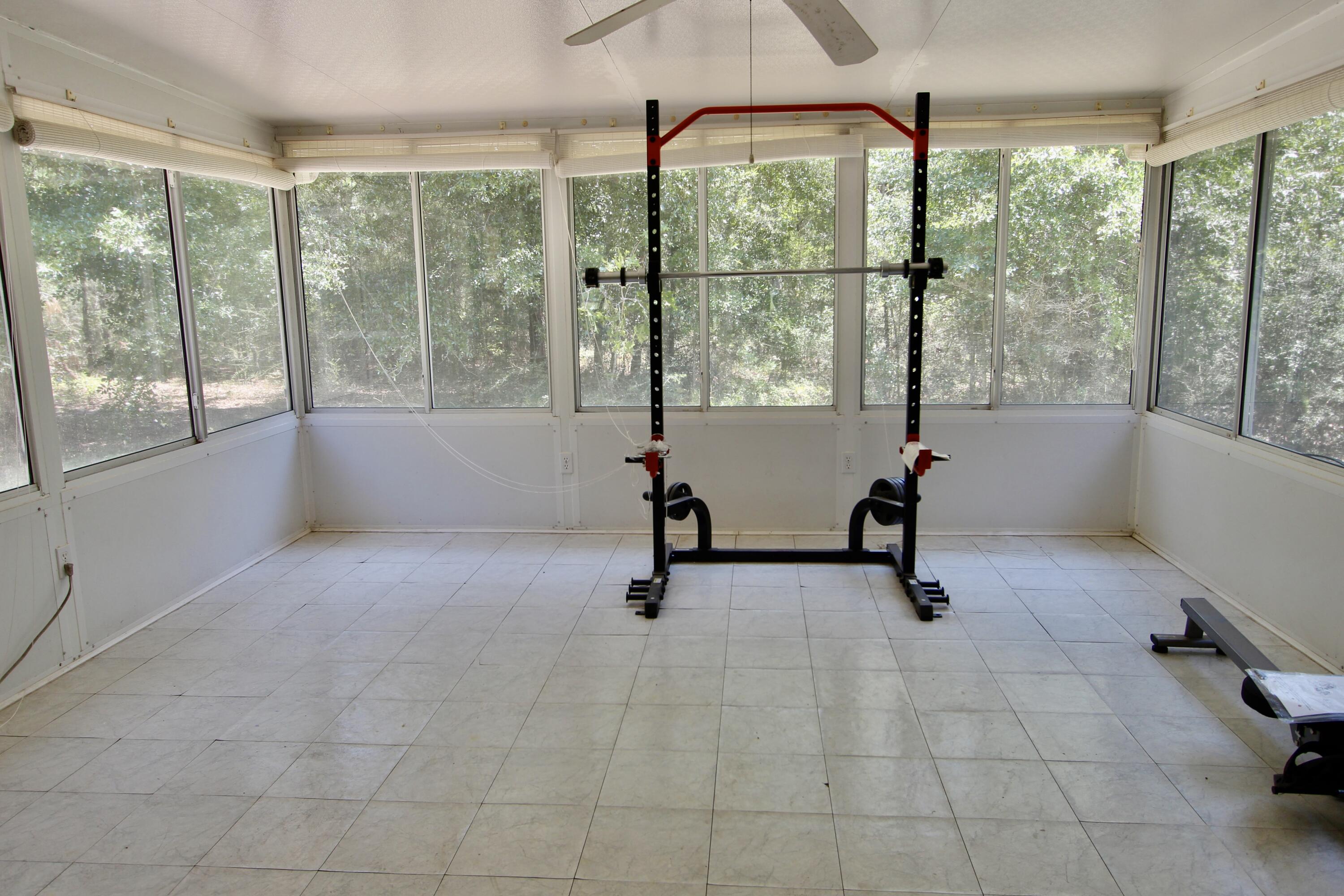 1088 Tallokas Road Crestview, FL 32536 - Photo 14 of 16 a view of a room with gym equipment and windows