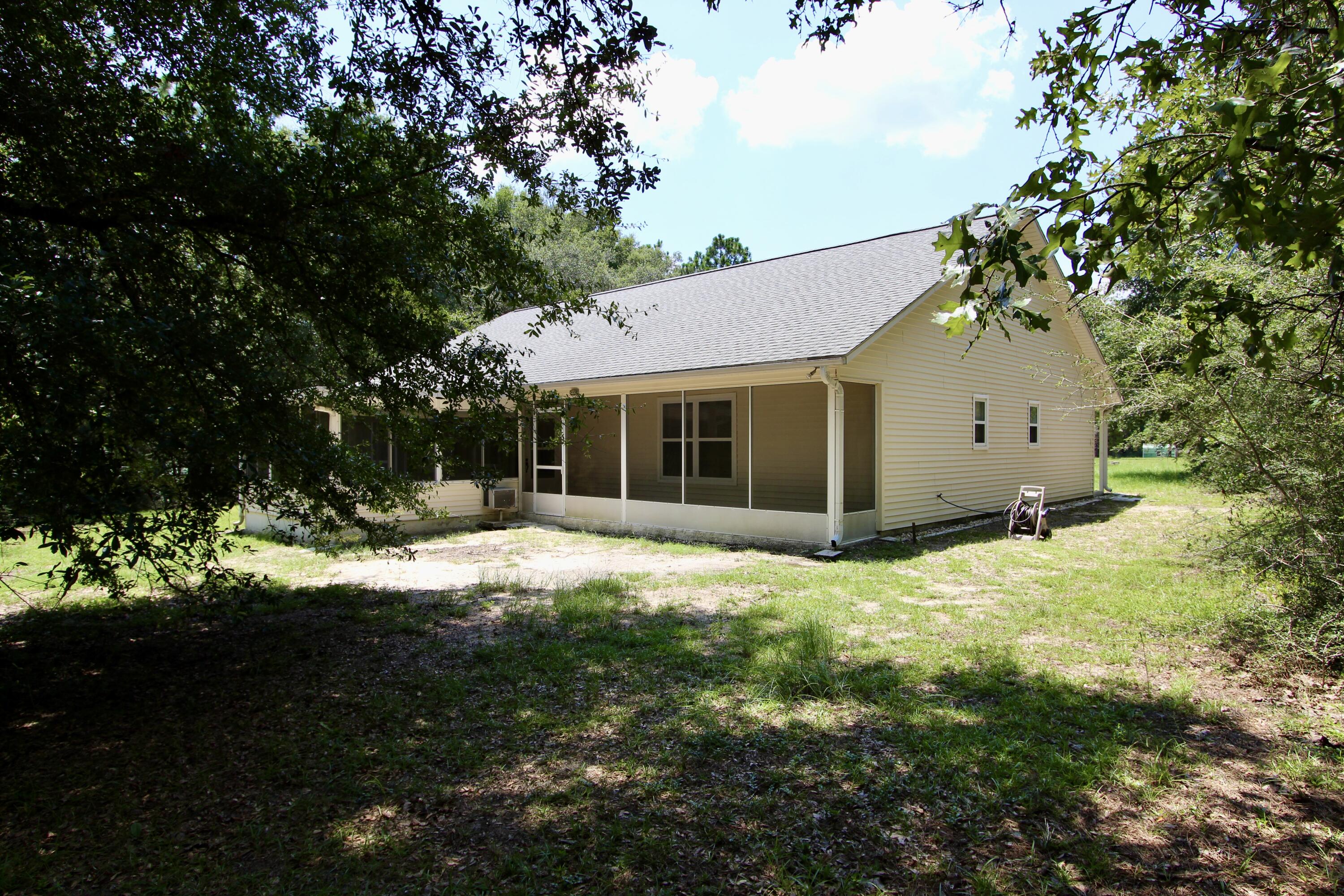 1088 Tallokas Road Crestview, FL 32536 - Photo 15 of 16 a backyard of a house with yard and outdoor seating