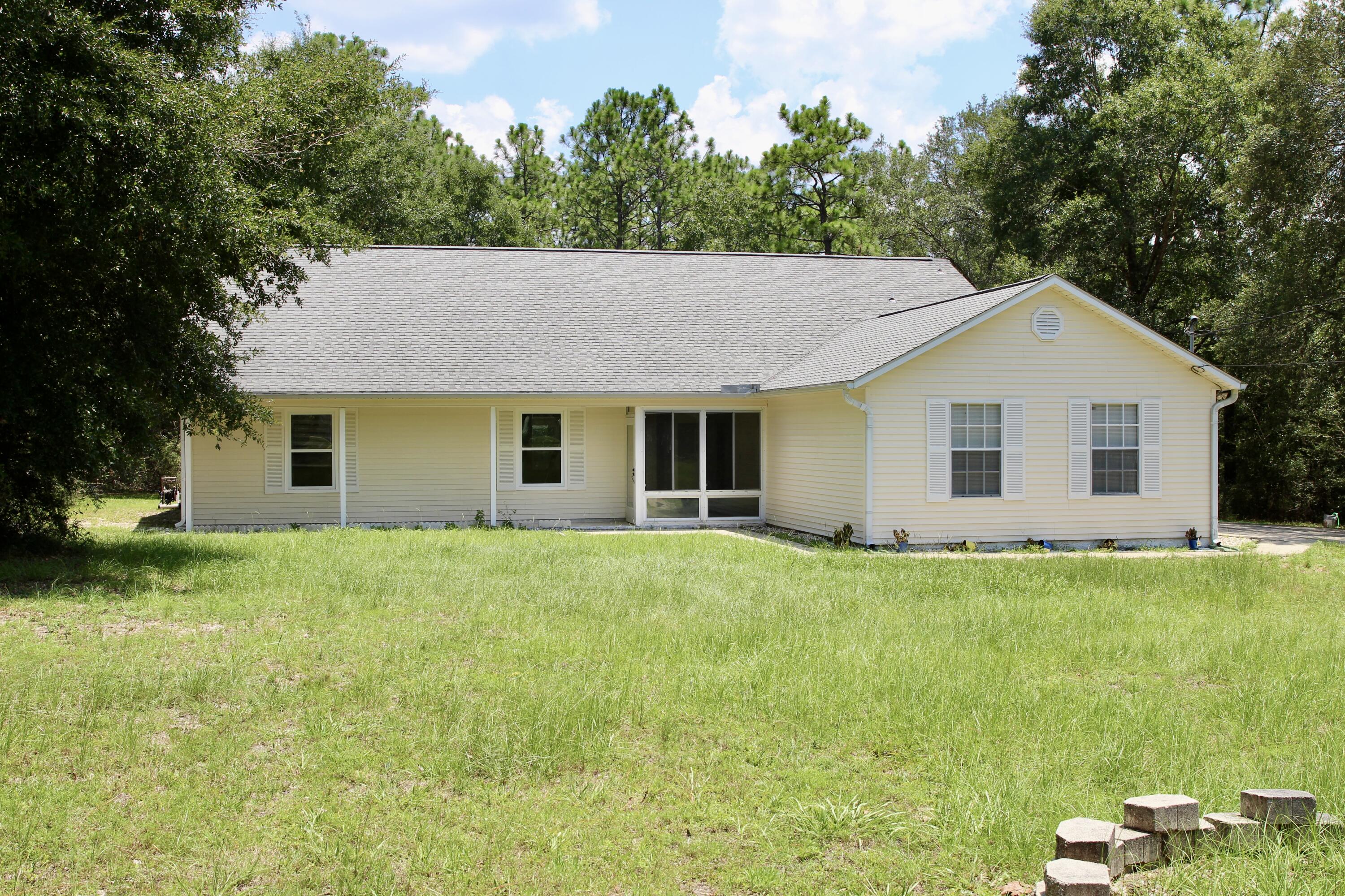 1088 Tallokas Road Crestview, FL 32536 - Photo 3 of 16 a view of a house with a backyard