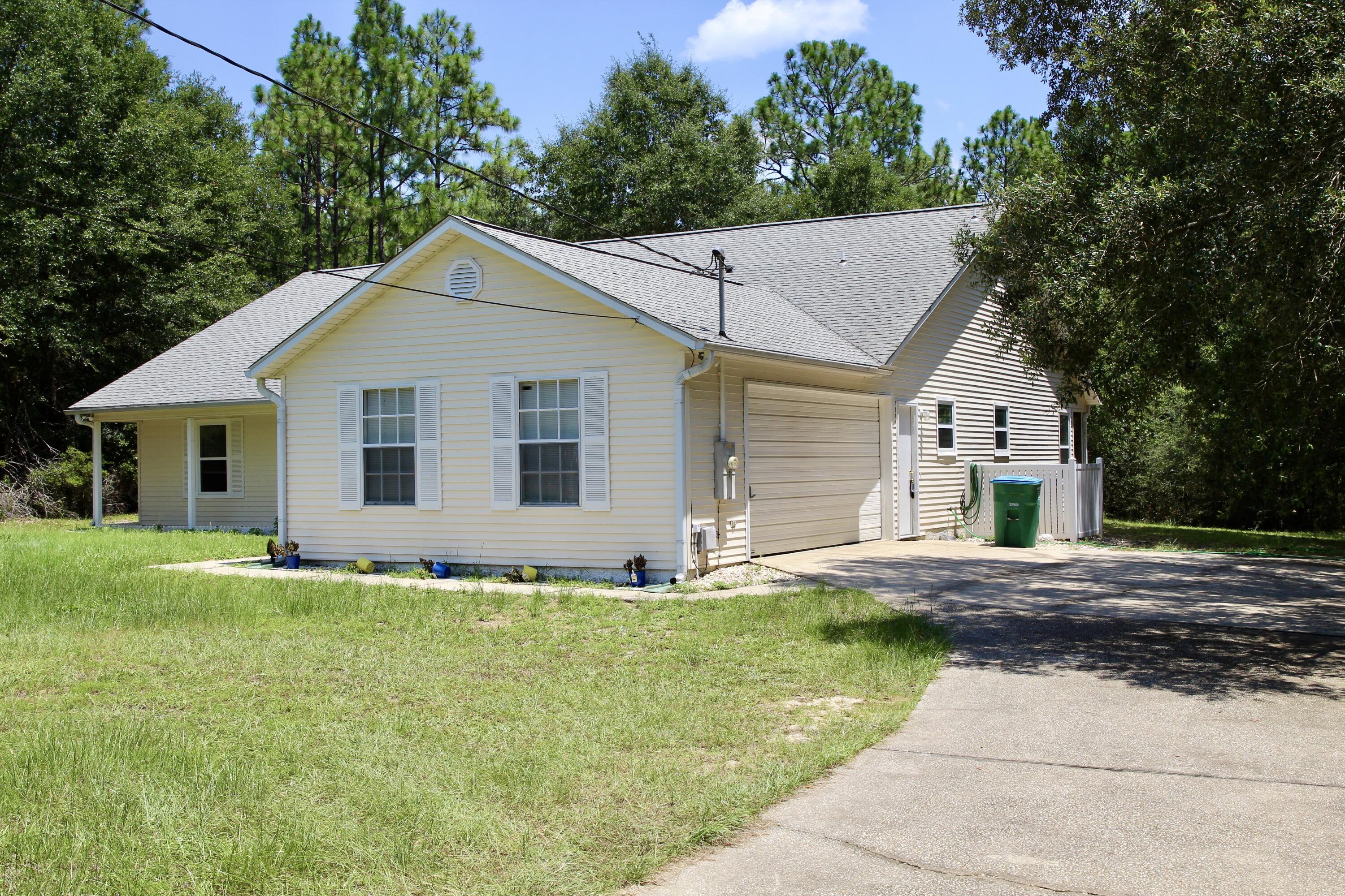 1088 Tallokas Road Crestview, FL 32536 - Photo 4 of 16 a big white house with a yard and large trees
