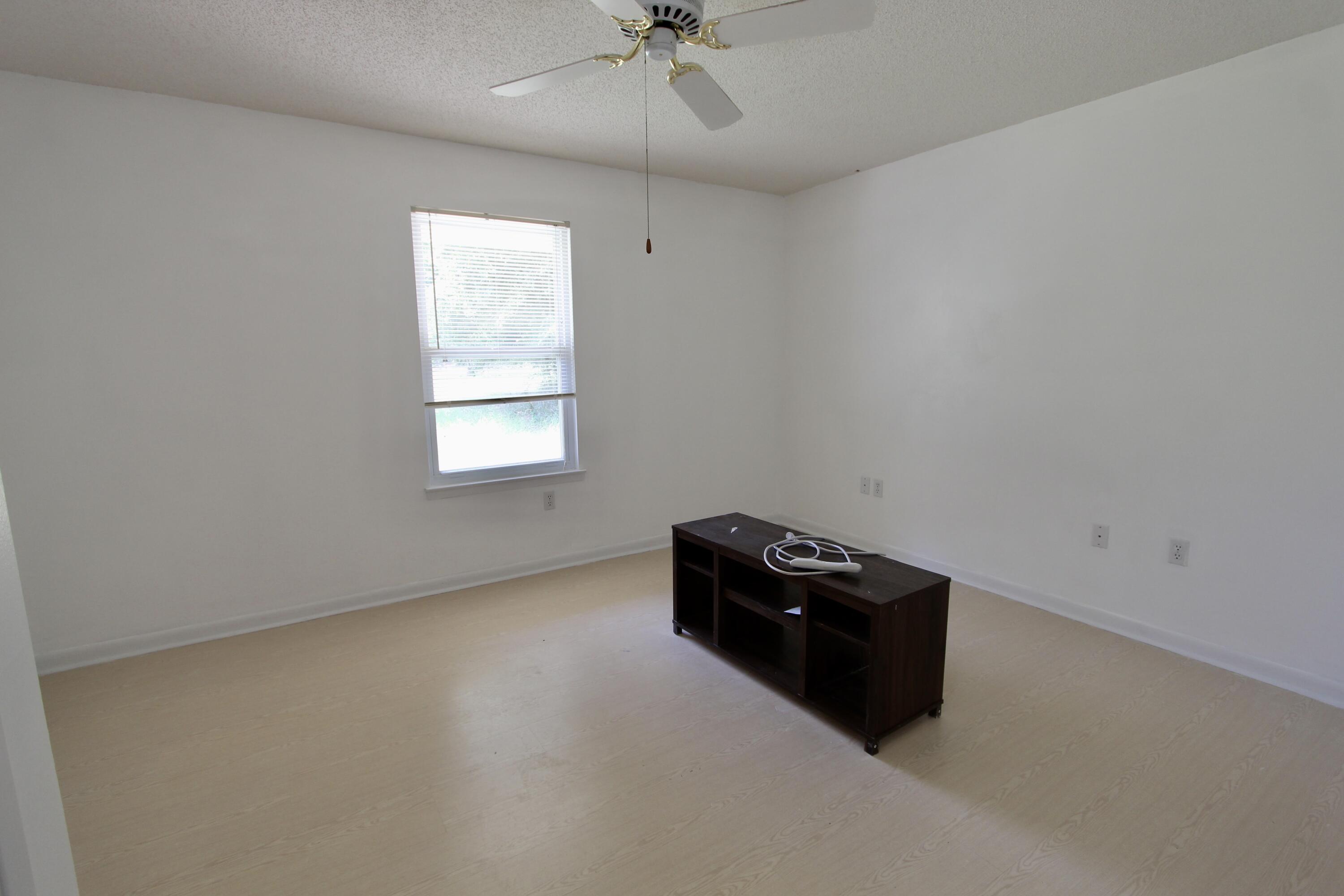1088 Tallokas Road Crestview, FL 32536 - Photo 9 of 16 an empty room with a ceiling fan and window