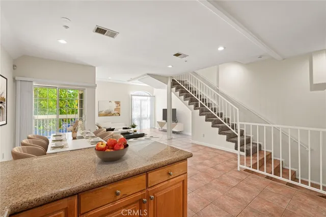 a living room with furniture stairs and a window