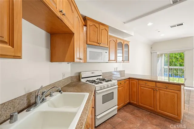 a kitchen with a sink stove and microwave