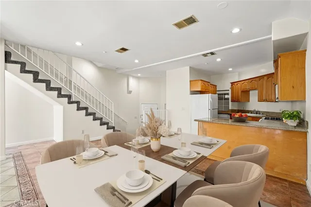 a dining room with furniture and a kitchen view