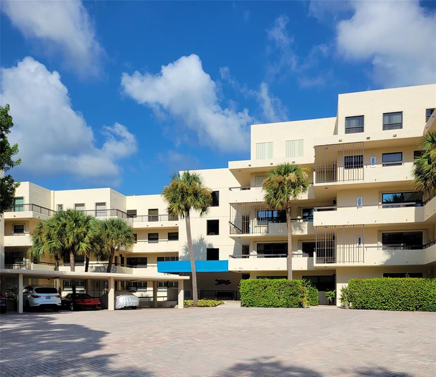 364 Golfview Road, Unit 507 North Palm Beach, FL 33408 - Photo 1 of 25 a front view of a building with cars parked