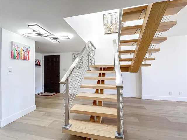a view of entryway and hall with wooden floor