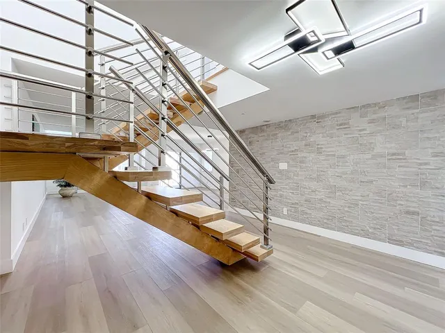 a view of a room with wooden floor