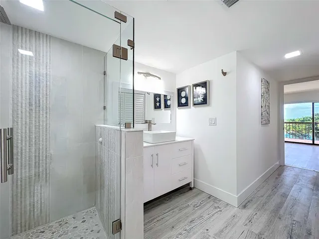 a bathroom with a double vanity sink toilet and shower