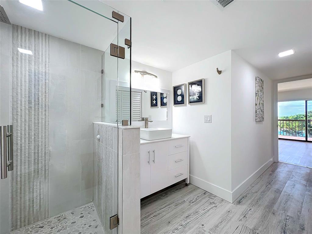 364 Golfview Road, Unit 507 North Palm Beach, FL 33408 - Photo 18 of 25 a bathroom with a double vanity sink toilet and shower
