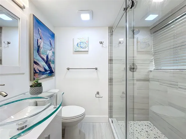 a bathroom with a toilet sink and shower